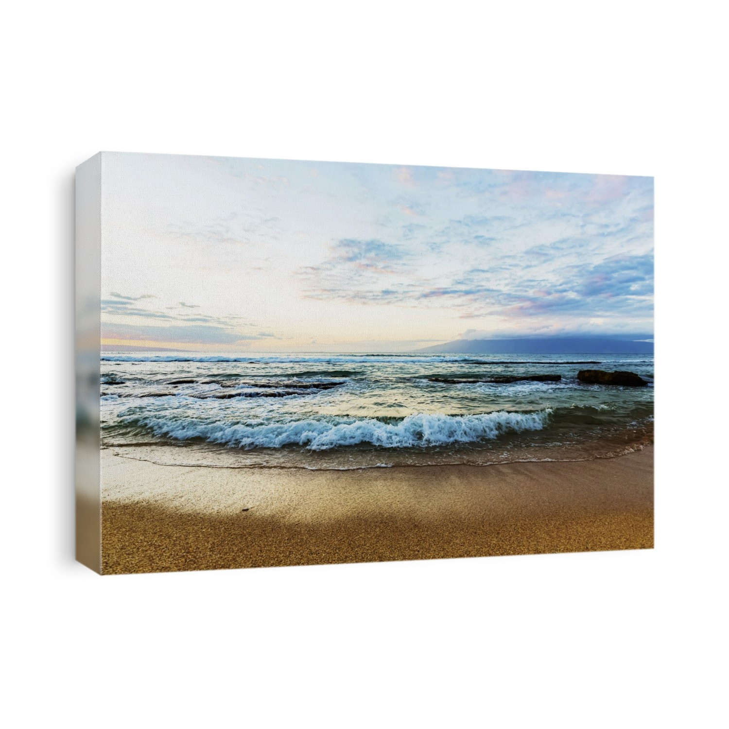 Ocean waves rolling over the large rocks at Ka'anapali Beach at sunset with the Island of Molokai on the horizon in the distance; Ka'anapali, Maui, Hawaii, United States of America