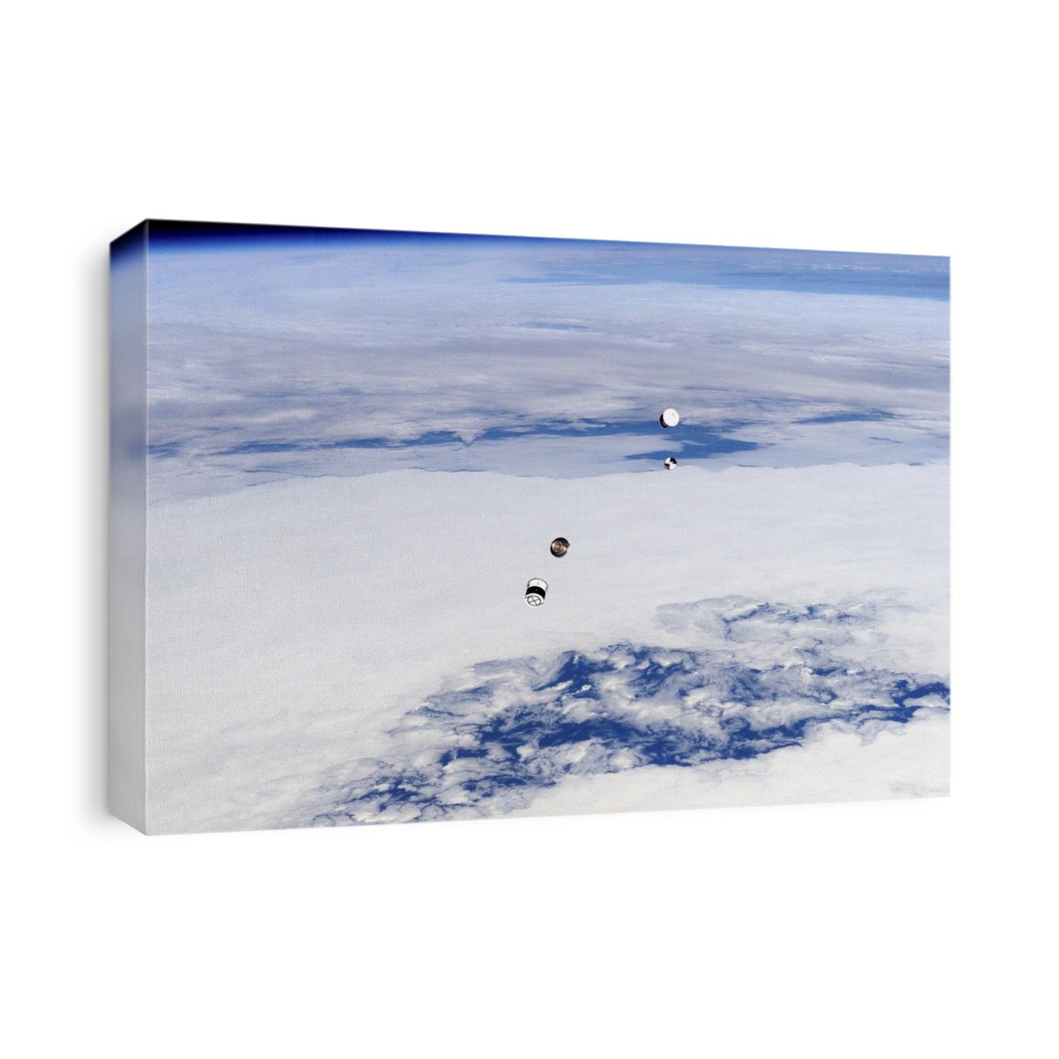 ANDE satellites being deployed from their canisters in low Earth orbit (LEO). There were two Atmospheric Neutral Density Experiment (ANDE) satellites, each one a precision engineered small metal sphere, one made of brass and one made of an aluminium alloy. The brass FCAL sphere is the lower object at upper right. The MAA sphere got stuck in its canister (lower left), and was deployed a day later. The experiment was designed to compare atmospheric drag on the satellites and model the density of the atmosphere in LEO. The satellites also demonstrated new radio technology. They were deployed on 21 December 2006 from the Space Shuttle Discovery during mission STS-116 (10-22 December 2006).