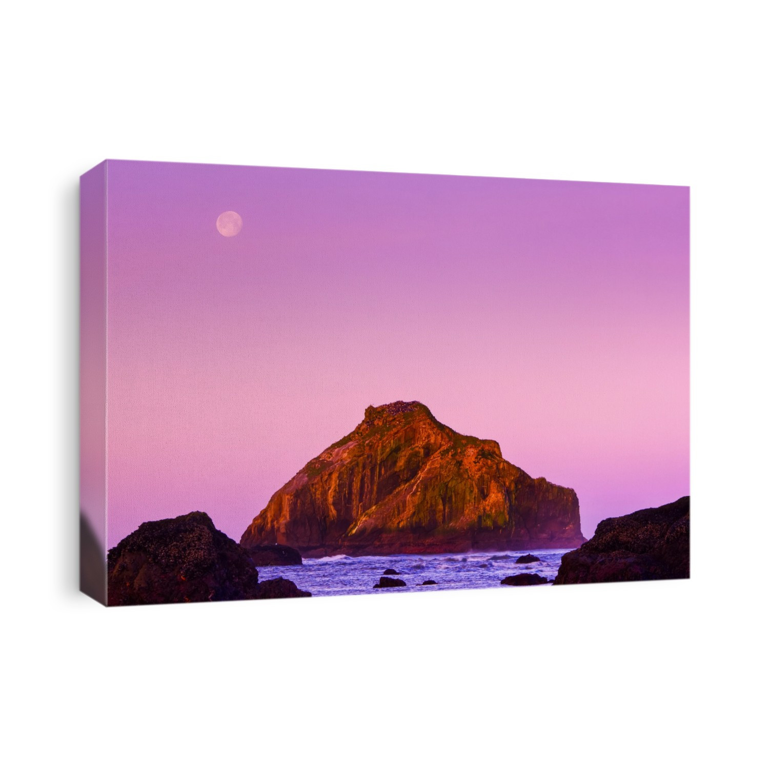 A glowing pink sky over a rock formation along the Oregon coast at dusk; Oregon, United States of America