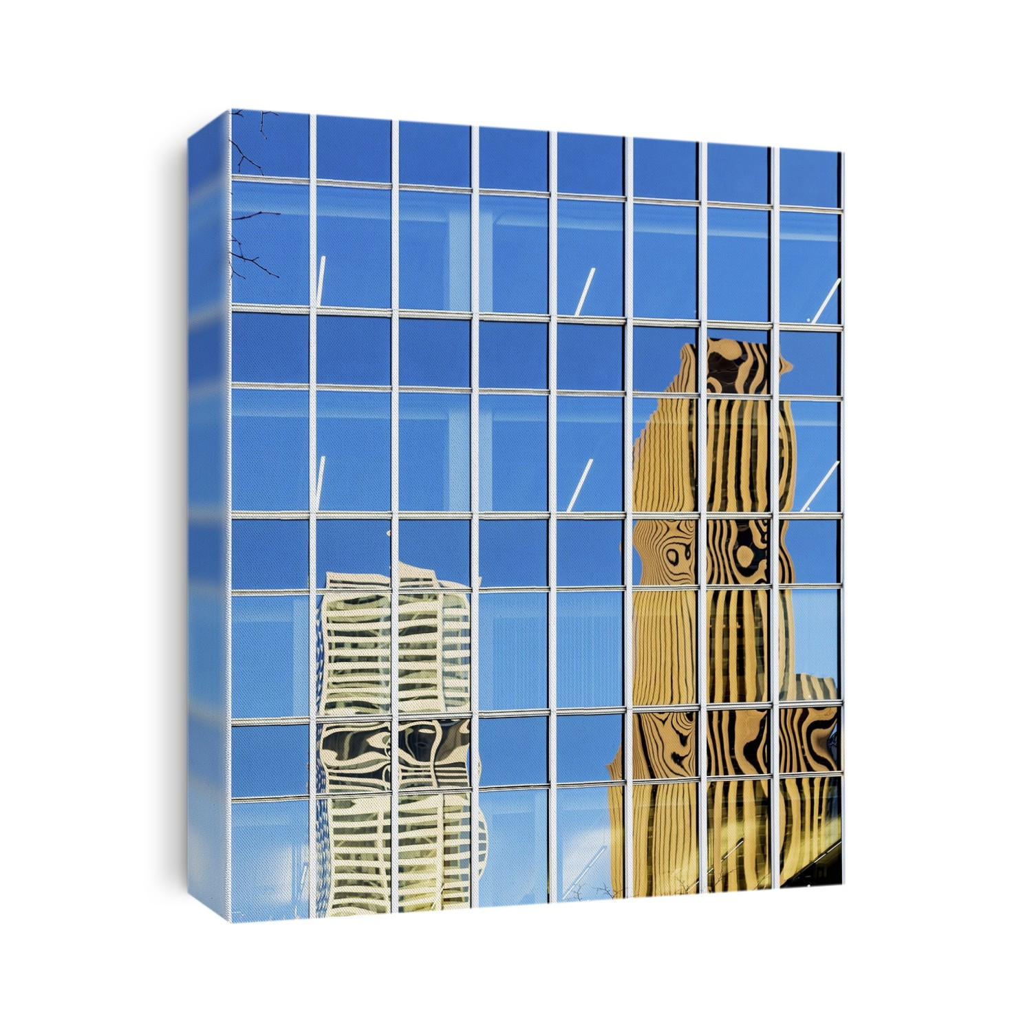 Modern buildings reflected in the glass exterior of an office building.