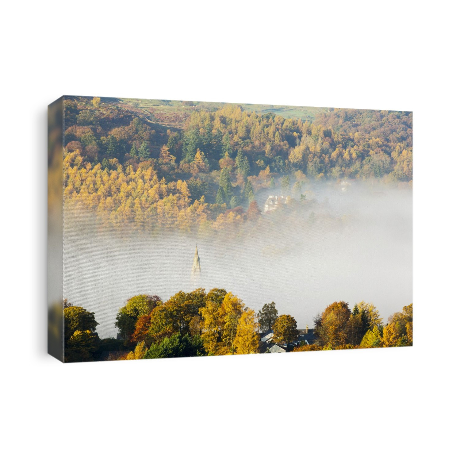Looking down on mist over Ambleside, Lake District, UK. The spire of St Mary's church is poking through the mist. Photographed in autumn.
