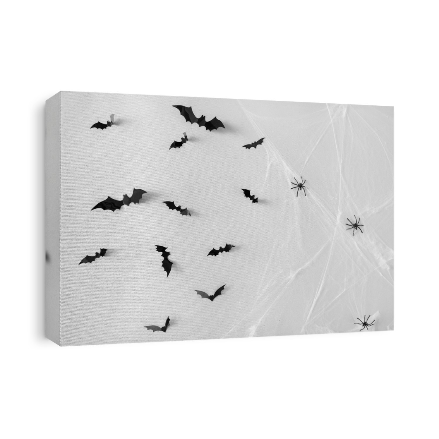 halloween, decoration and scary concept - black flying bats and spiders on web over white background