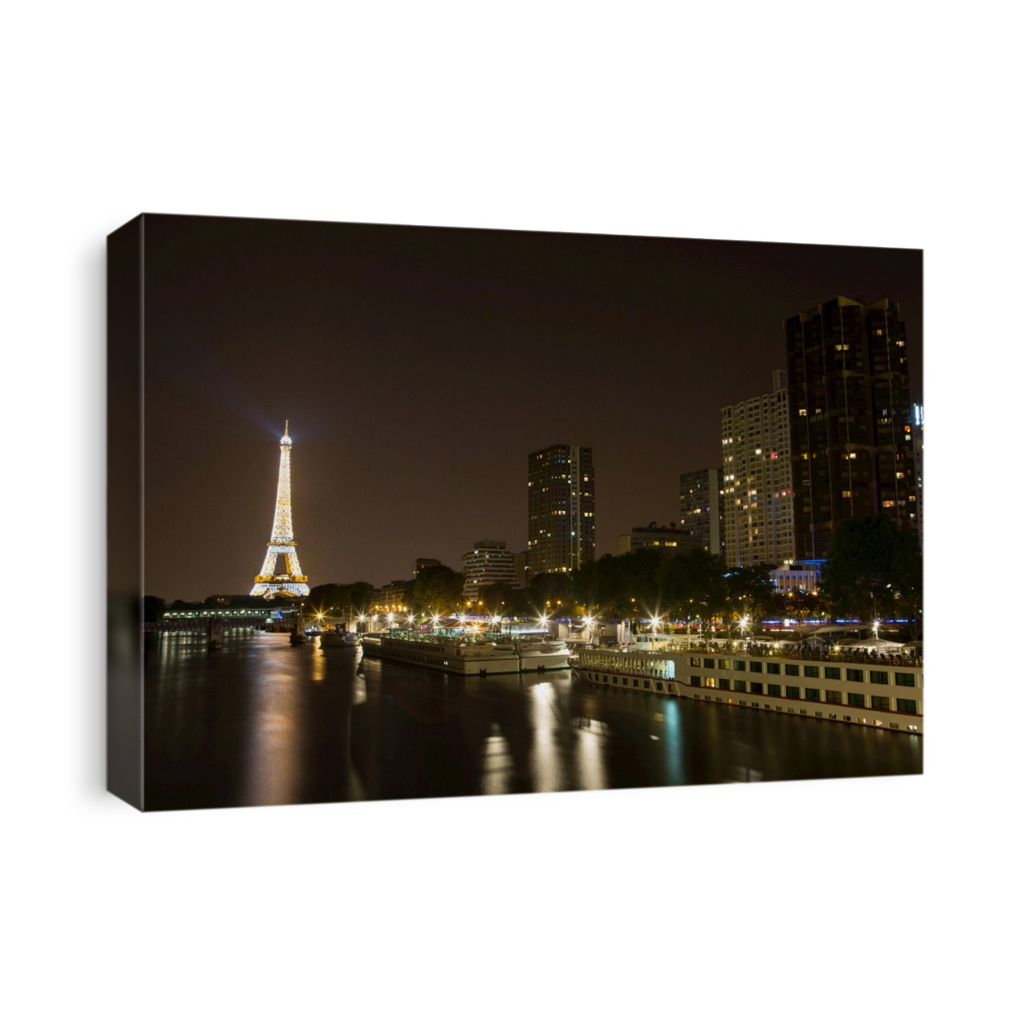 The Eiffel Tower, Seine River and Paris cruise boats at night.; Paris, France