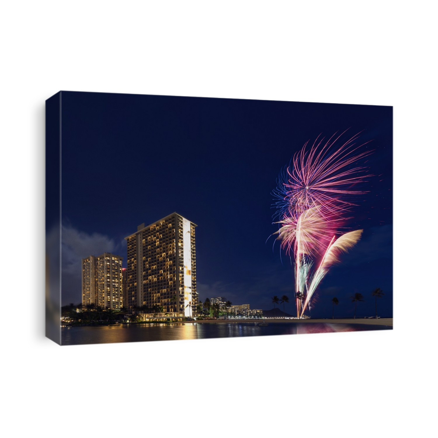 Condominiums and fireworkds along the coastline of Waikiki at sunset; Honolulu, Oahu, Hawaii, United States of America