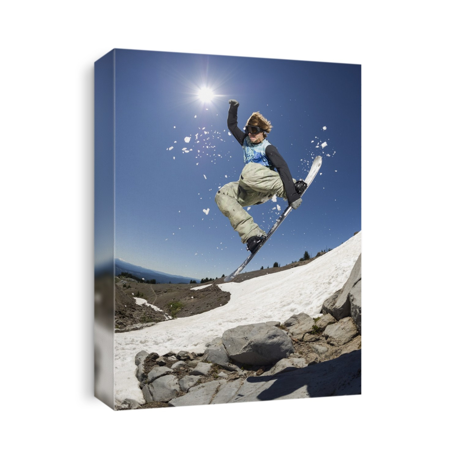 A professional, freeriding snowboarder mid-air on Mount Hood; Oregon, United States of America