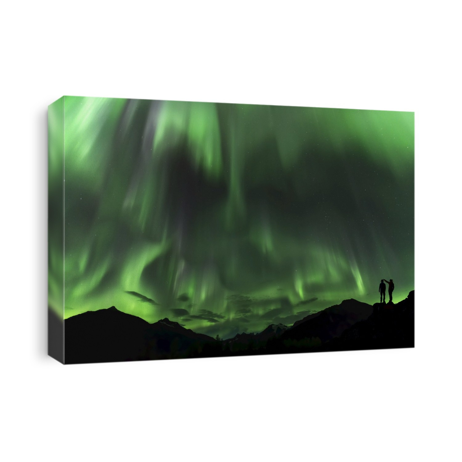 Silhouetted people and mountains with a green glowing Northern Lights display; Alaska, United States of America