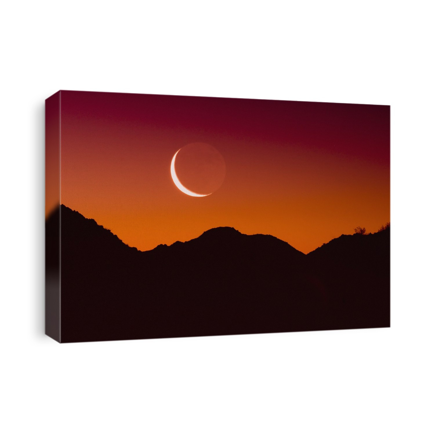 Sunrise over a mountain range in joshua tree national park with the moon in the sky; California united states of america