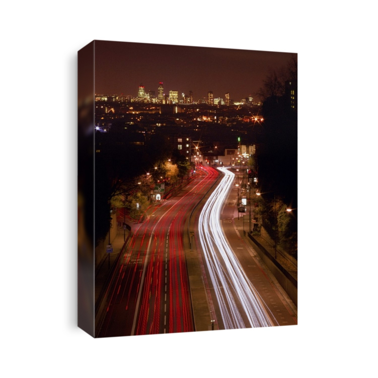 City traffic at night. Time-exposure image of vehicle lights on a road leading towards London. Photographed in the UK.