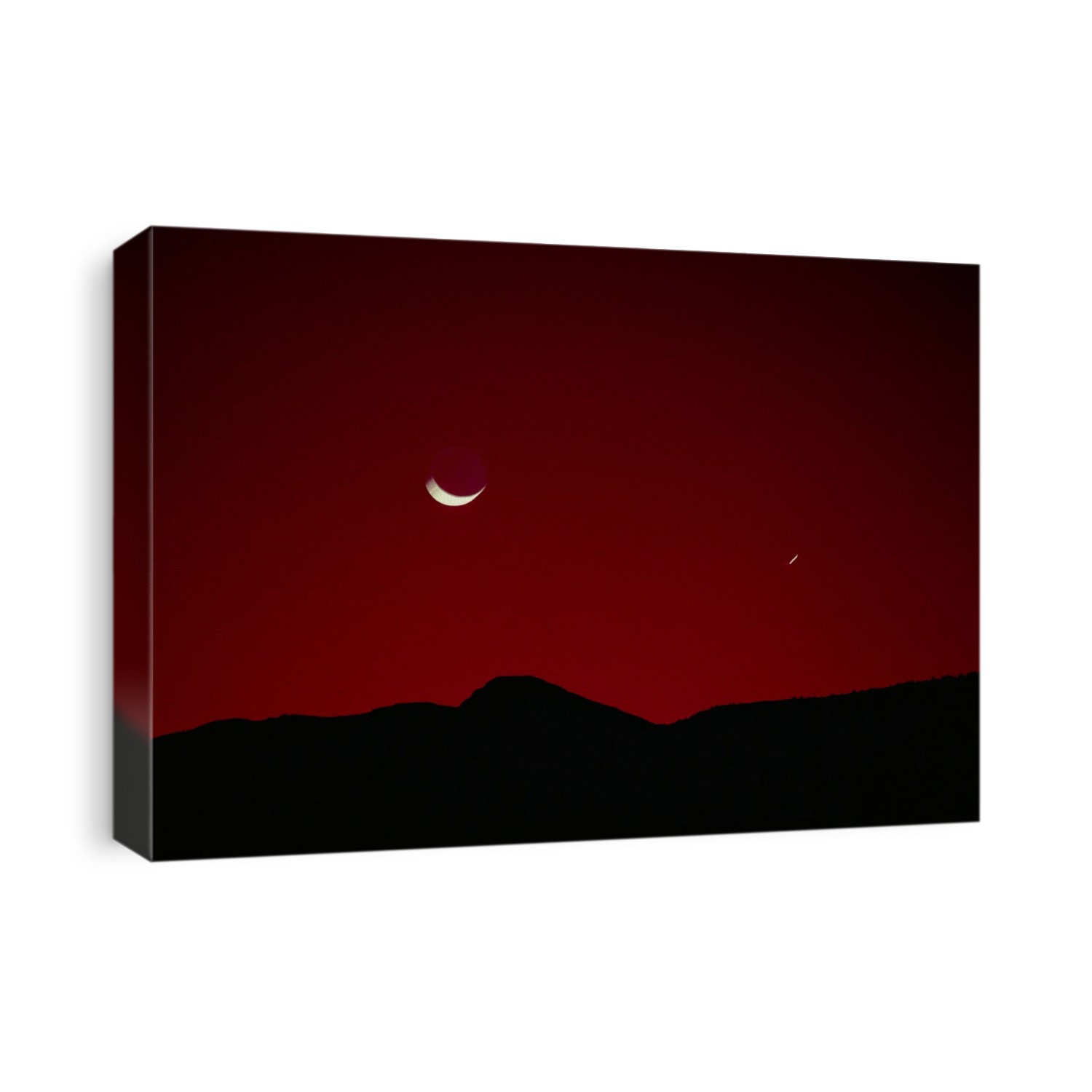 Time exposure of the crescent Moon (left) and the planet Mercury (small streak, right) in the morning sky.