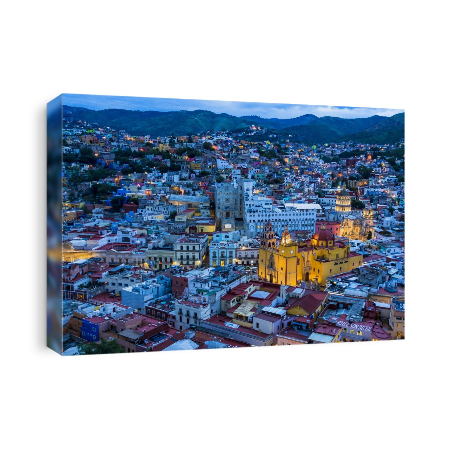 Overview of city at dusk with the Guanajuato Basilica painted in yellow in Guanajuato City, Guanajuato, Mexico