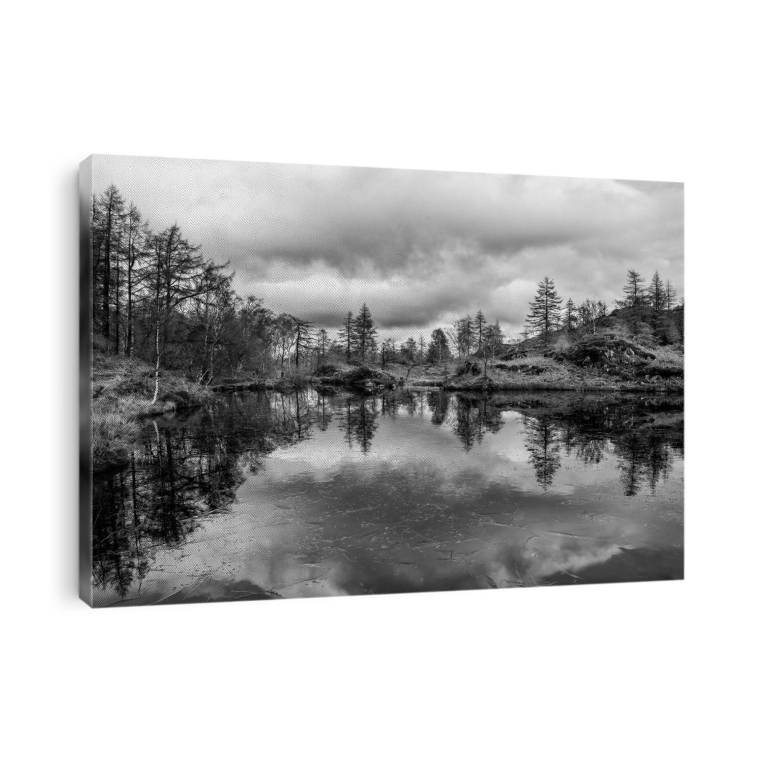 Epic Winter  black and white landscape image view from Holme Fell in Lake District towards snow capped mountain ranges in distance in glorious evening light