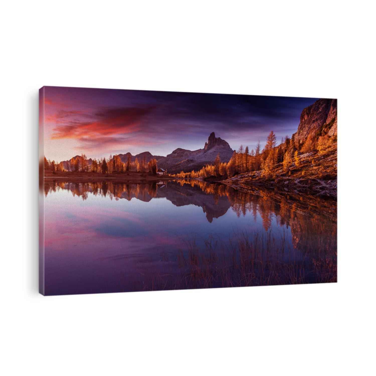 Amazing Autumn nature landscape. Scenic image of Famous Federa lake in Dolomites Alps during sunset. Beautiful sunrise with Lake and majestic Mountains. Iconic location for photographers