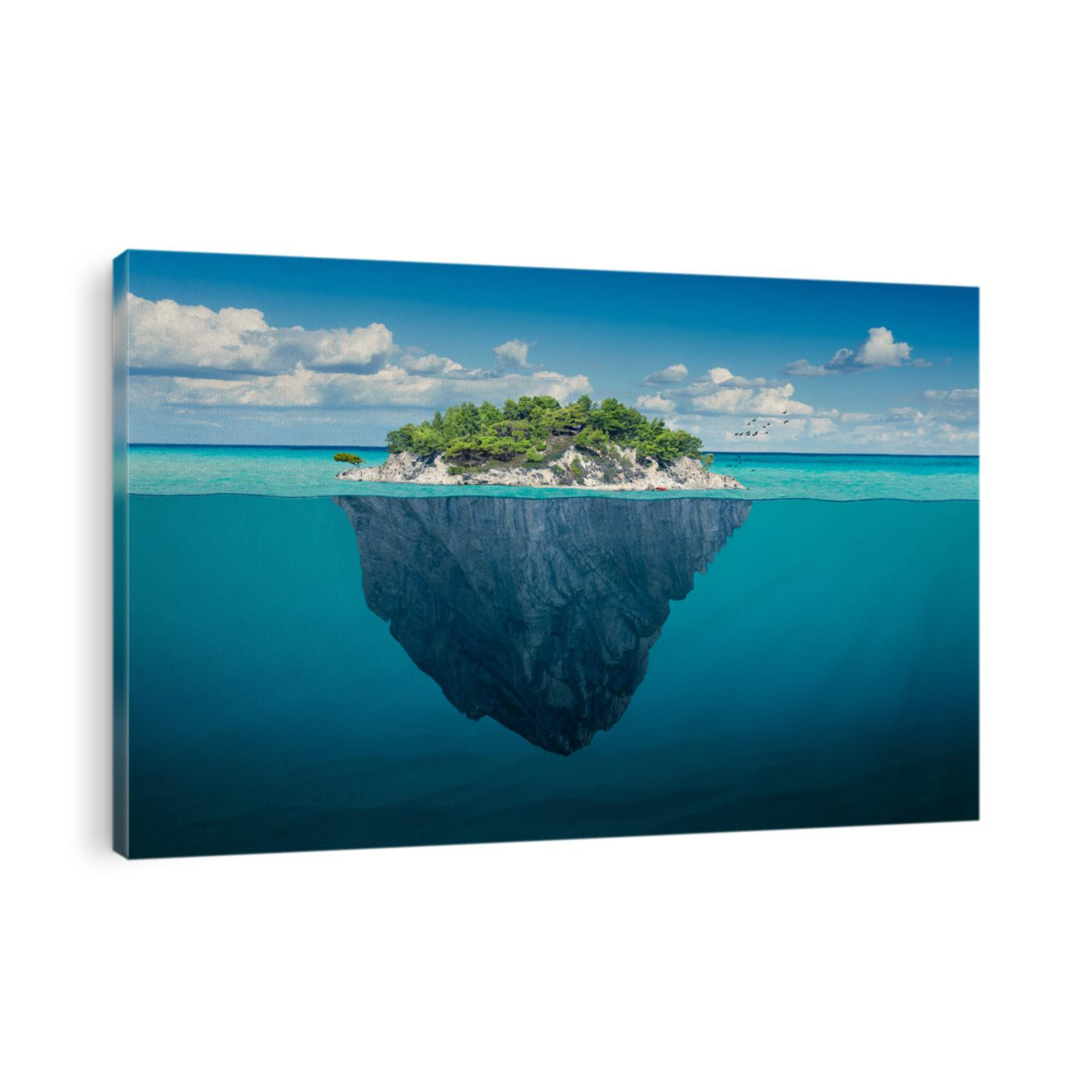 Beautiful underwater view of lone small island above and below the water surface in turquoise waters of tropical ocean.