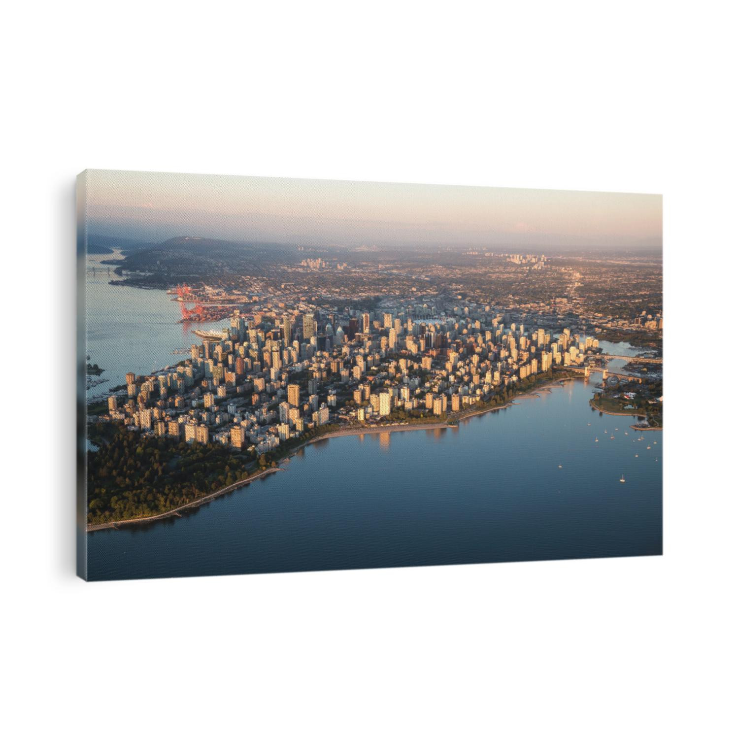 Aerial view of Stanley Park and Downtown Vancouver, BC, Canada. During a hazy sunny sunset.