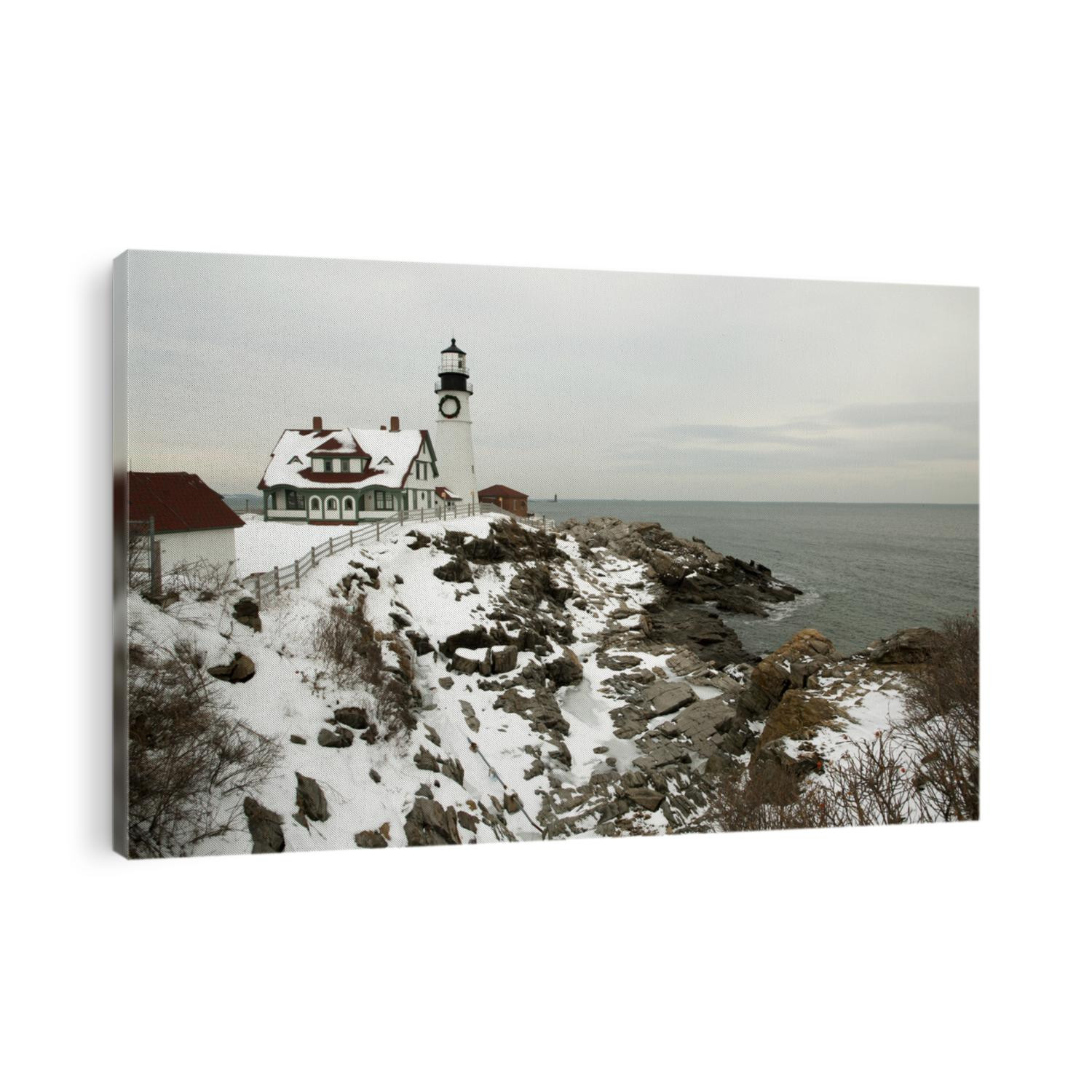 A large wreath hangs on the tower of Portland Head lighthouse in Maine to celebrate the holiday season after a New England snowfall. It is the oldest beacon in Maine.