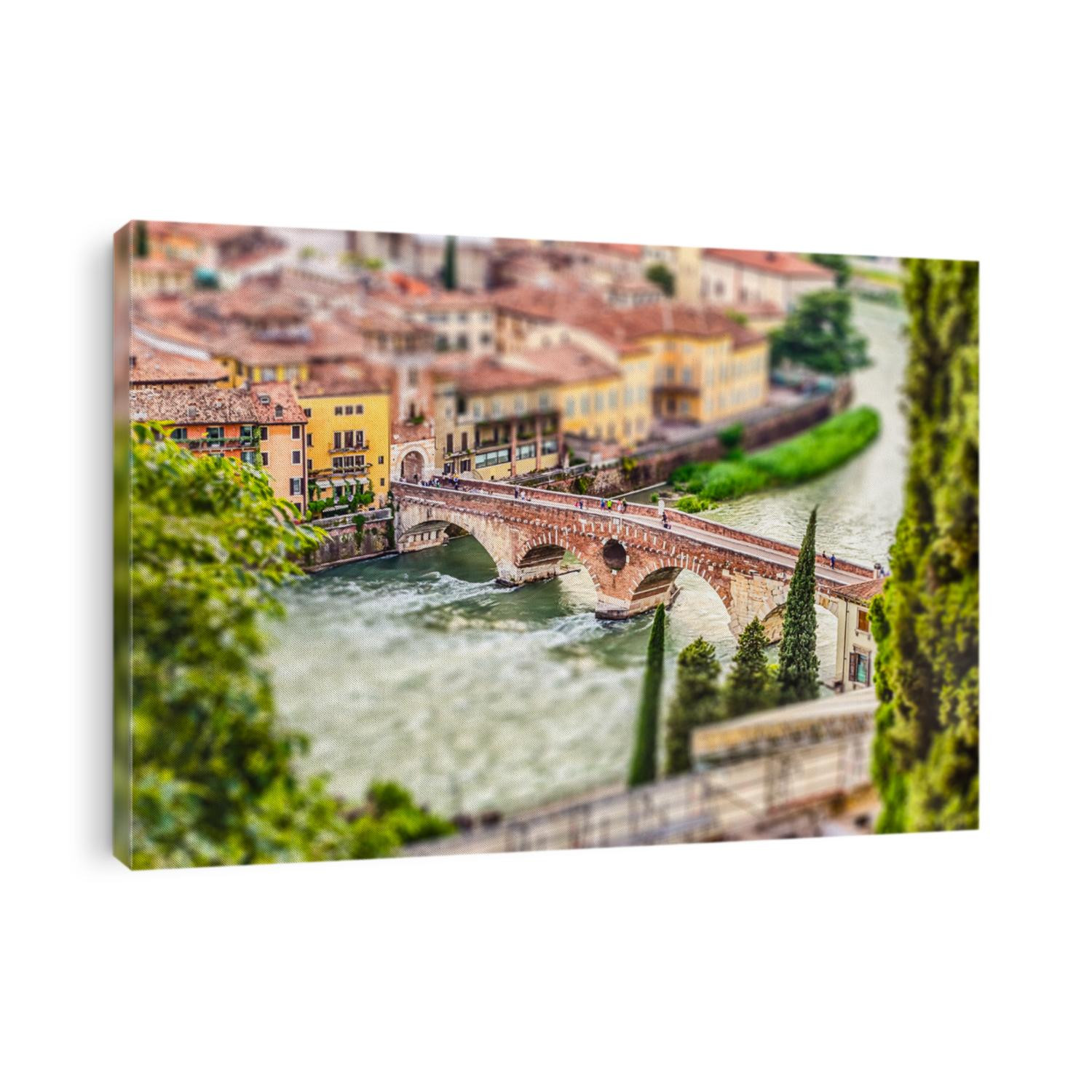 Ancient Roman Bridge called Ponte di Pietra above the Adige River in Verona, Italy. Tilt-shift effect applied