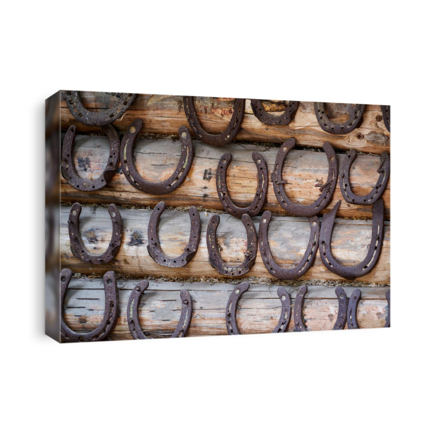 Old rusty horseshoe on a wooden background.
