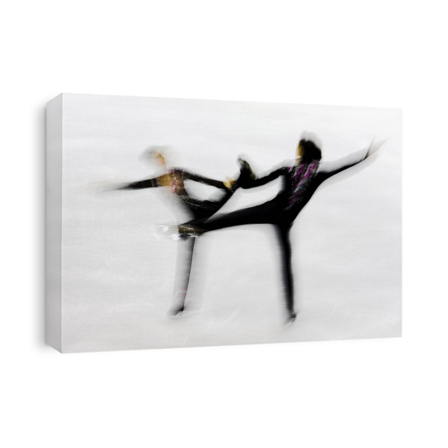 Blurred action of pairs figure skaters.