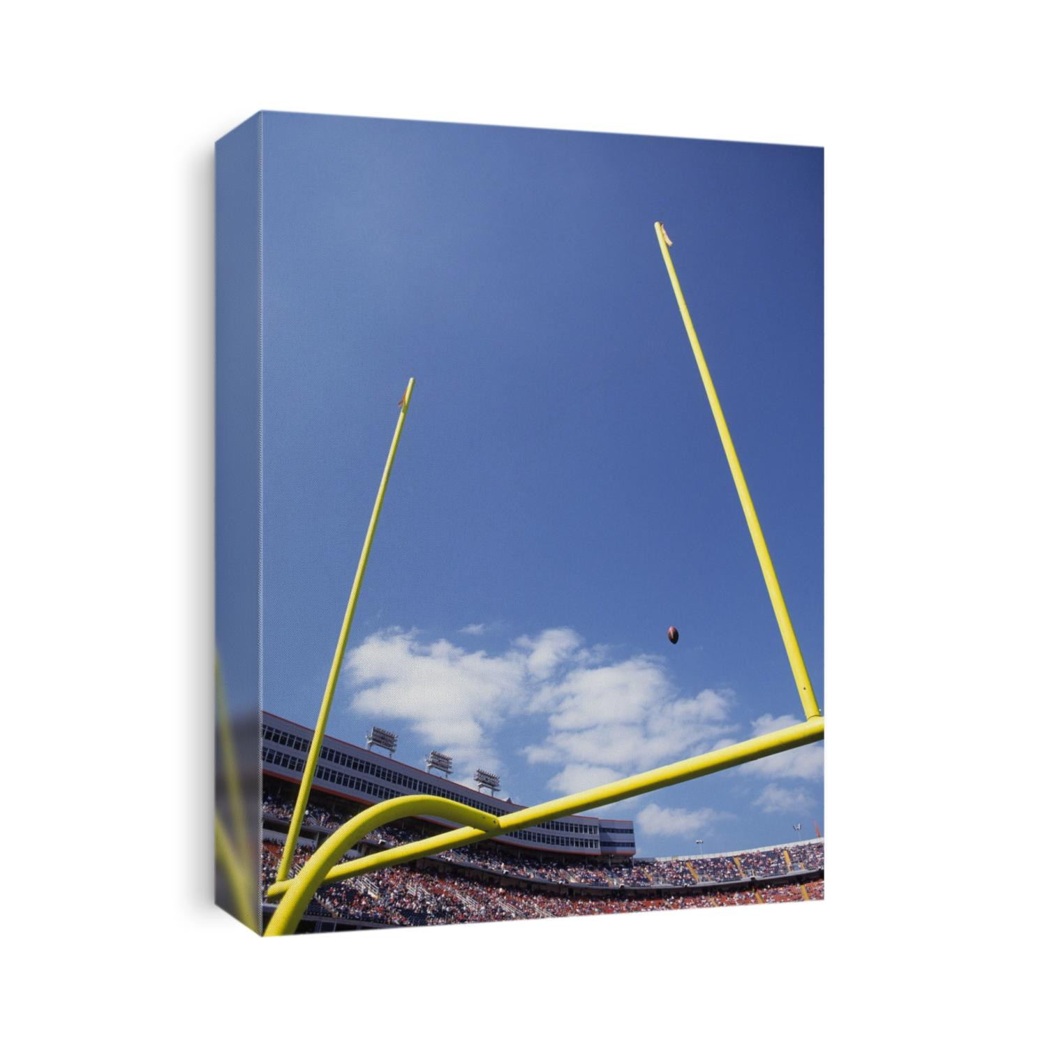 American fooball flying through the goalposts.