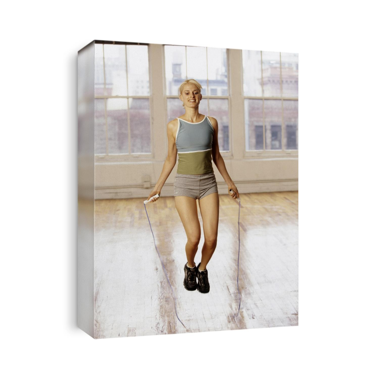Women working out with jump rope in fitness studio.