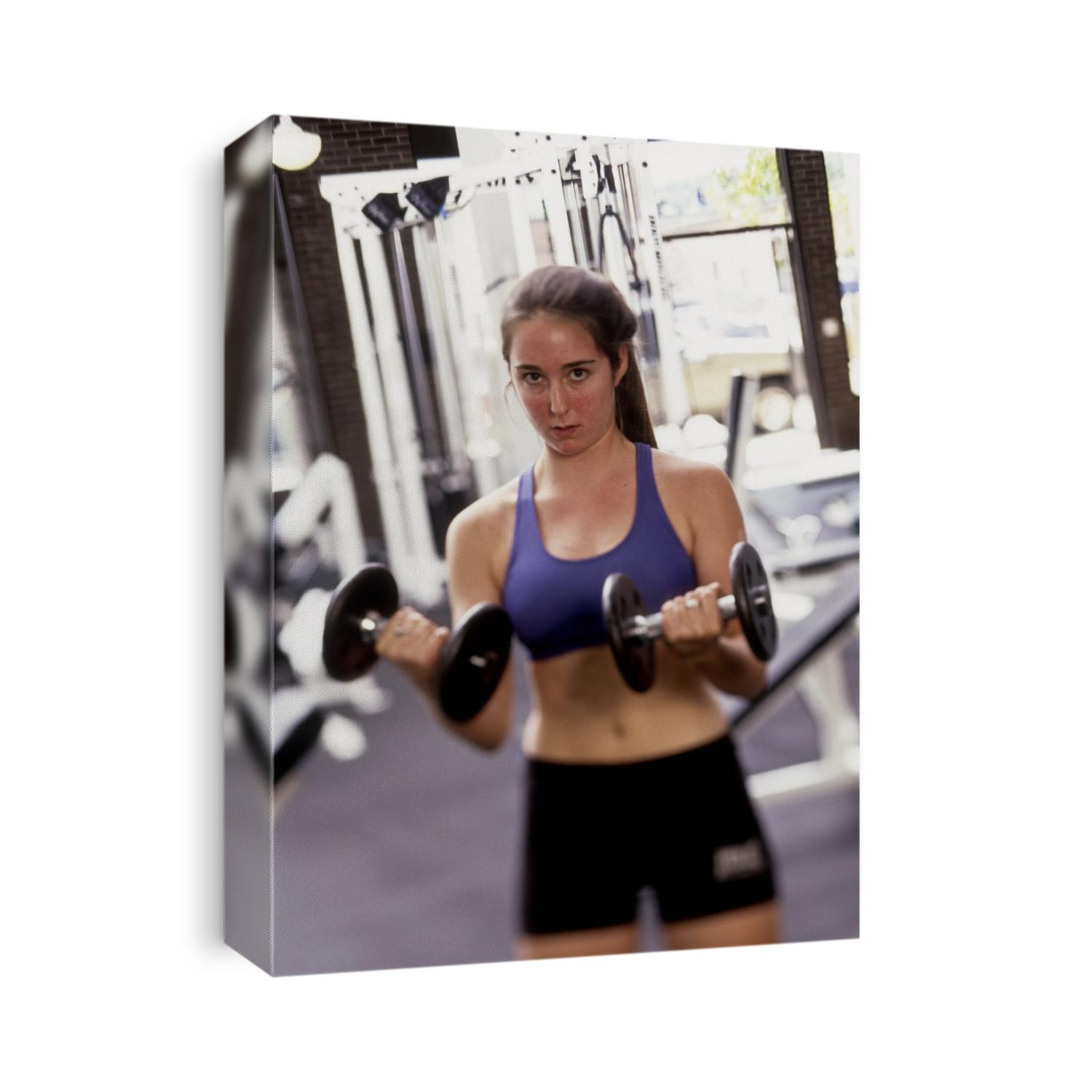 Young woman working out with hand weights,