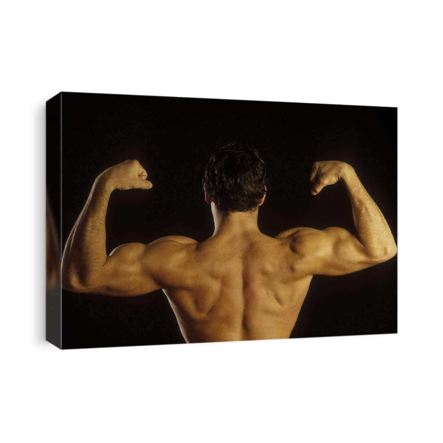 Young adult male posing with arms flexed.