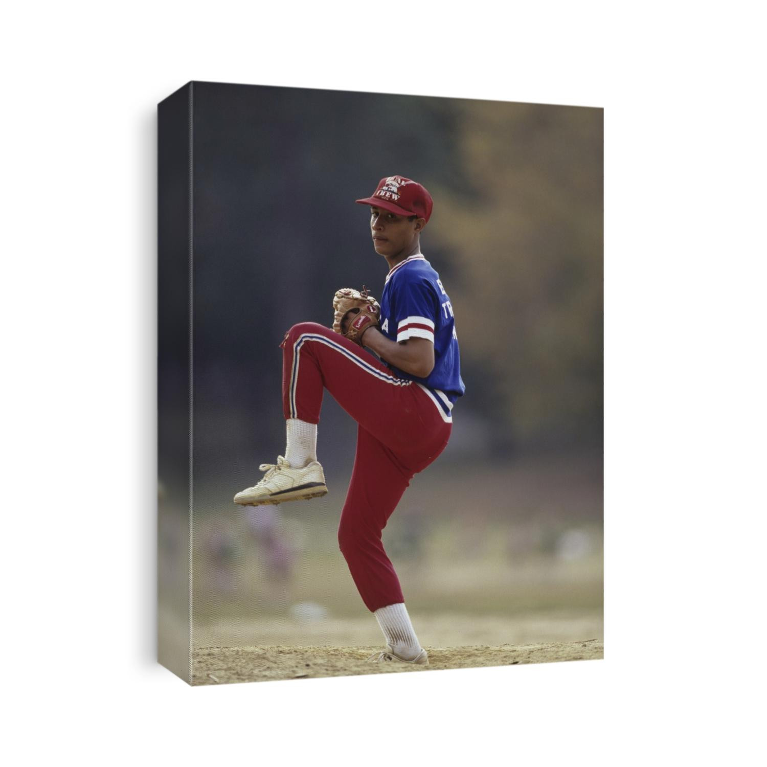 Young hispanic baseball pitcher in action.