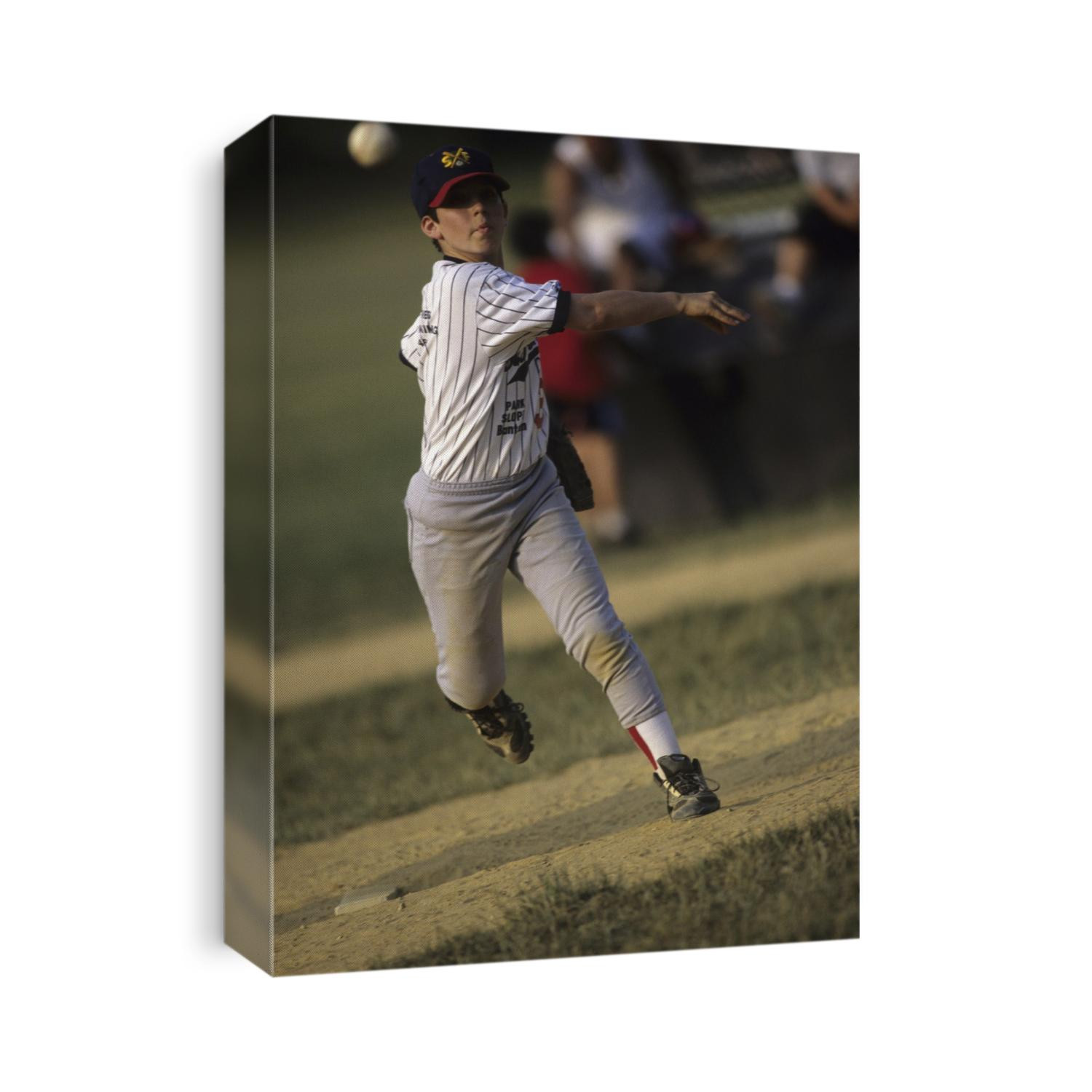 Young boy pitching during a little league baseball games.
