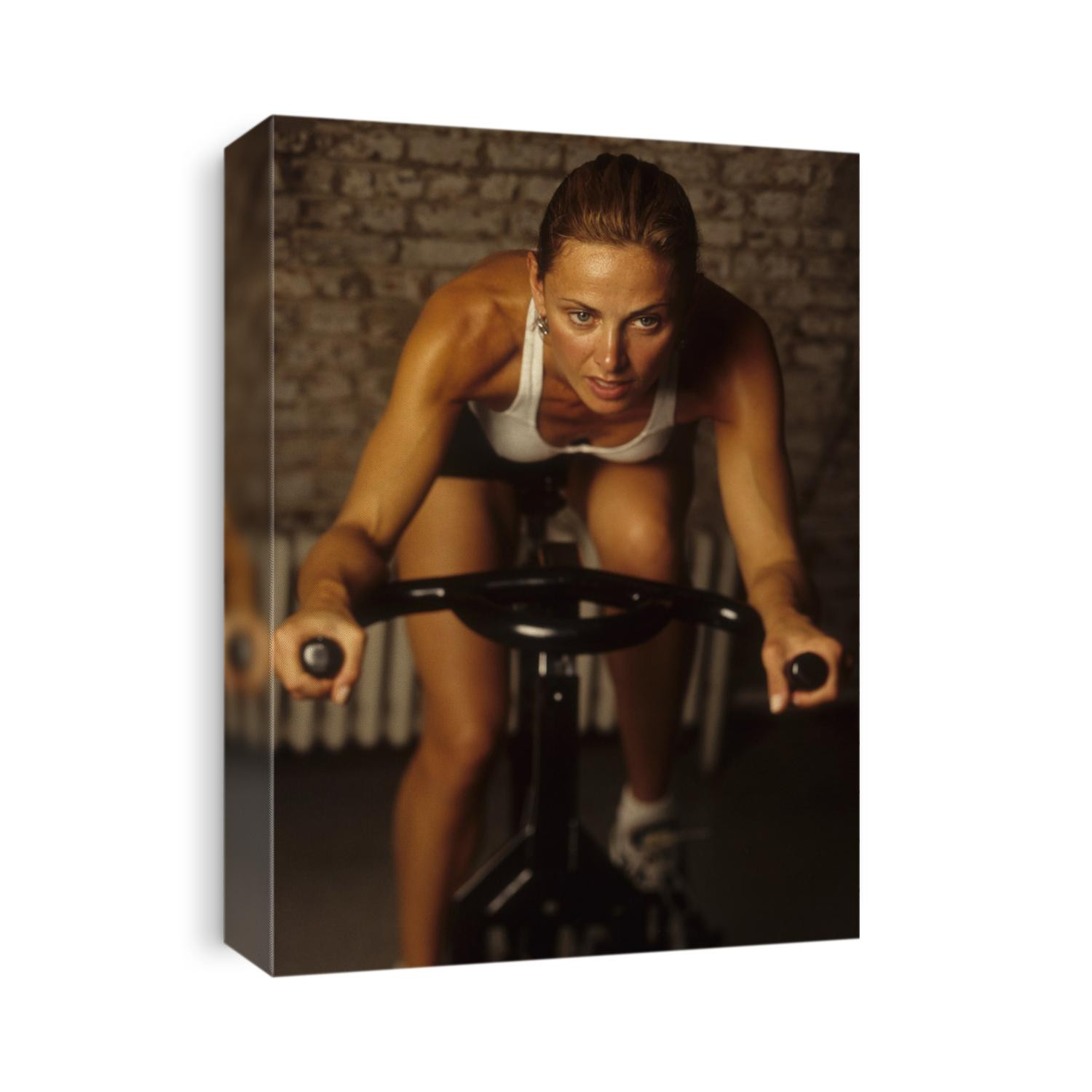 Young woman exercising on a stationary bike.