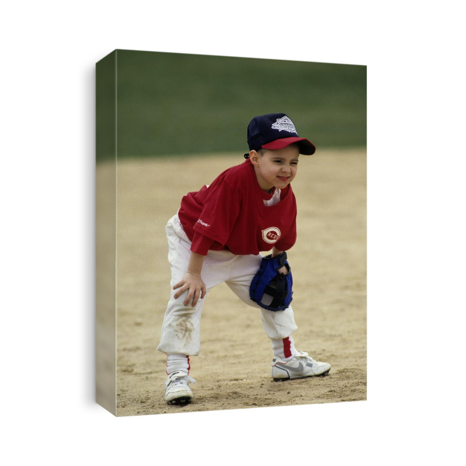 Young boy at short stop during a tee ball game.