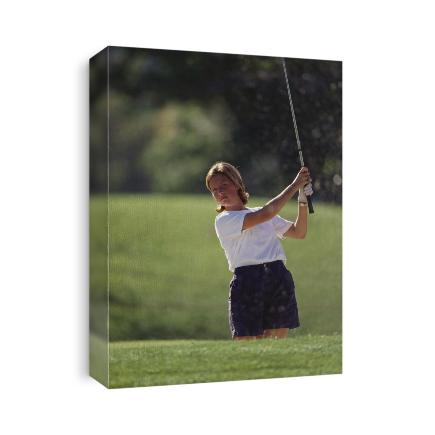Woman golfer in action.