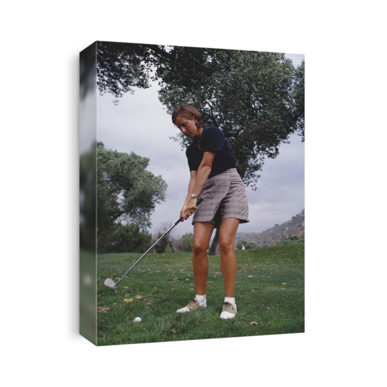 Woman golfer in action.