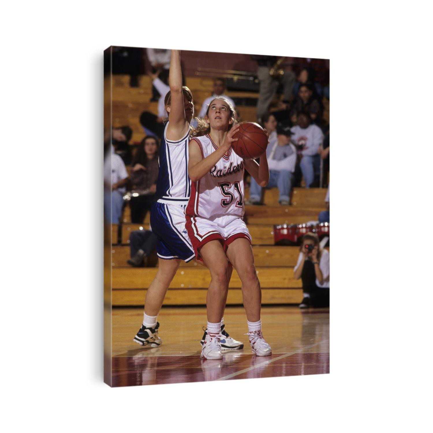 High School Girls basketball players in action during a game.