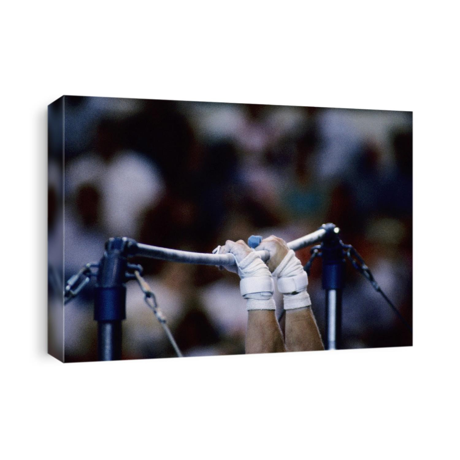 Detail of the hands of male gymnast grabing the high bar