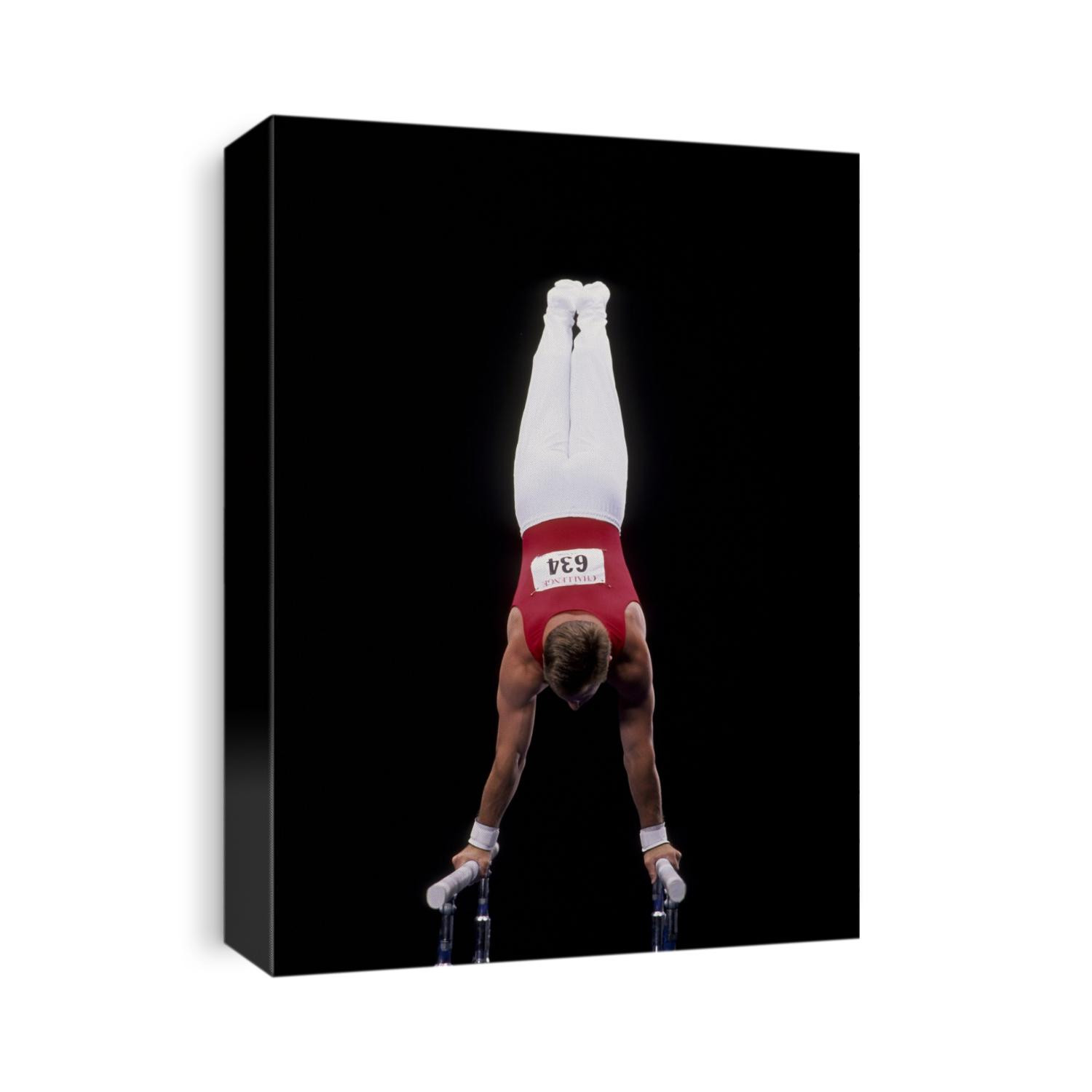 Male gymnast on the parallel bars.