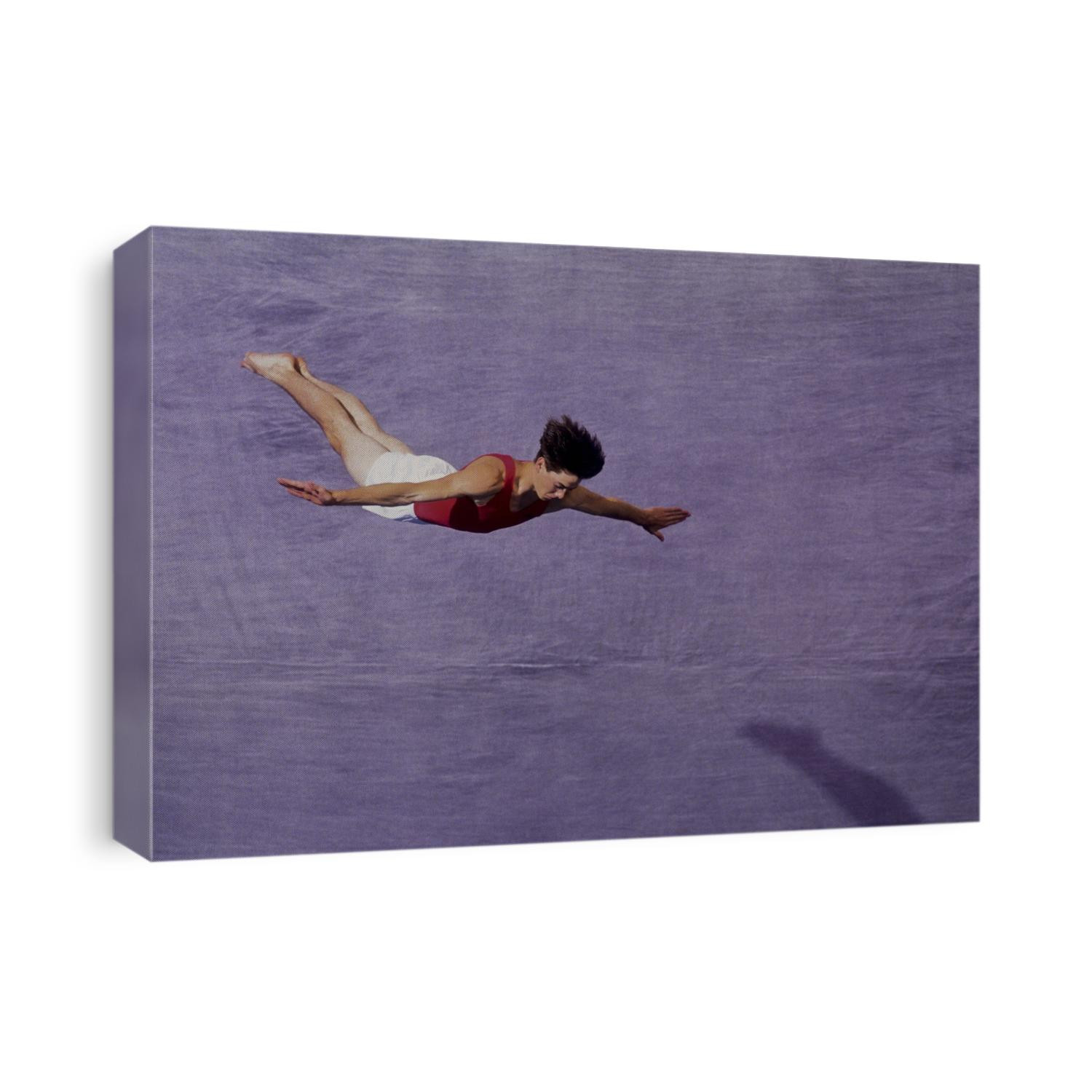 Male gymnast performing on the floor exercises.