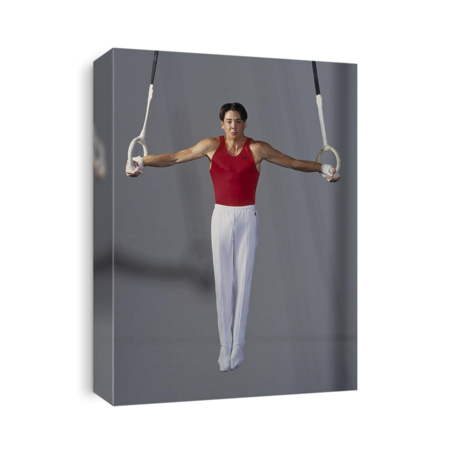Male gymnast on the rings.