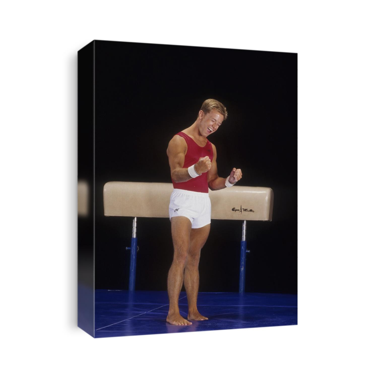 Male gymnast react to succeful performance on the pommel horse