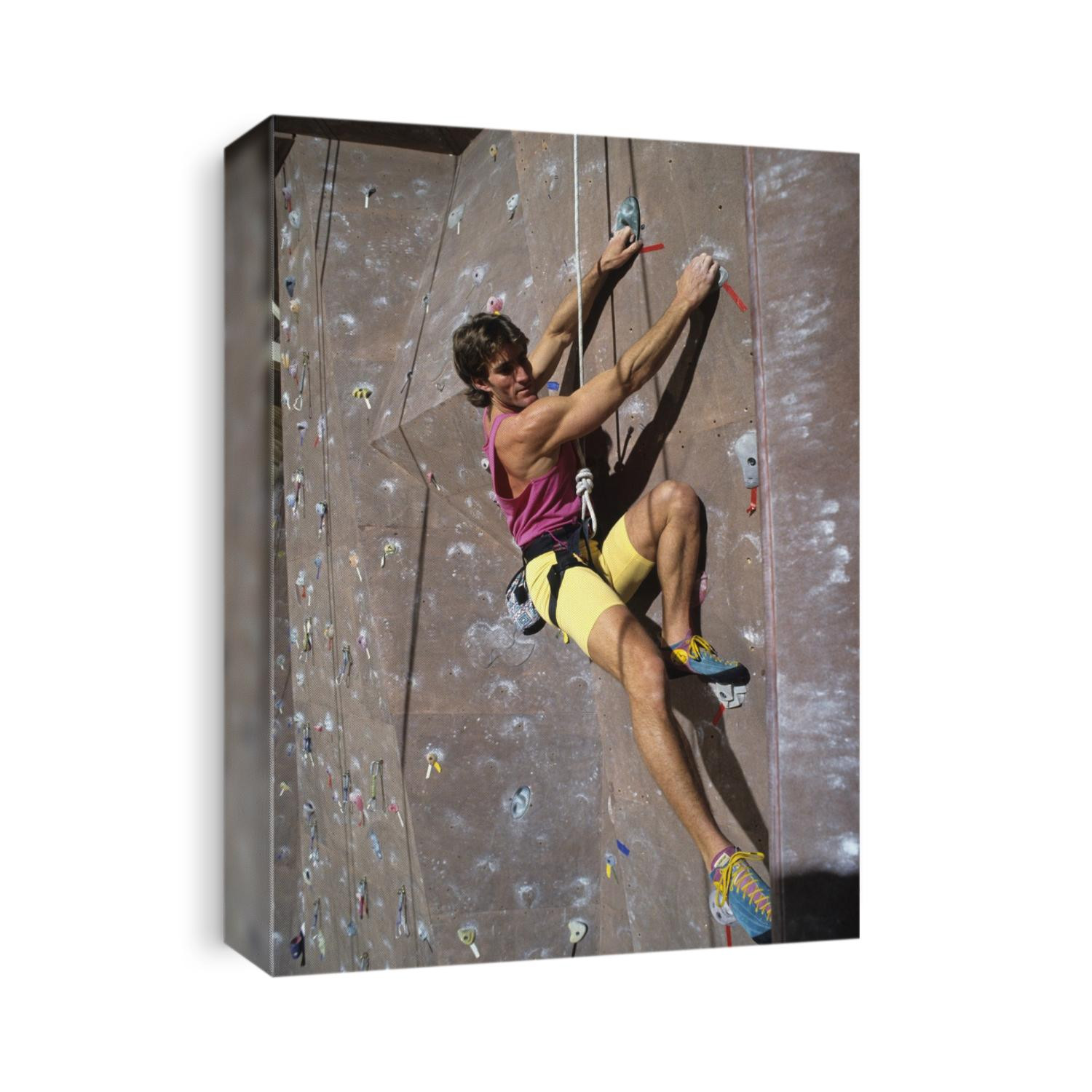 Man wall climbing indoors.