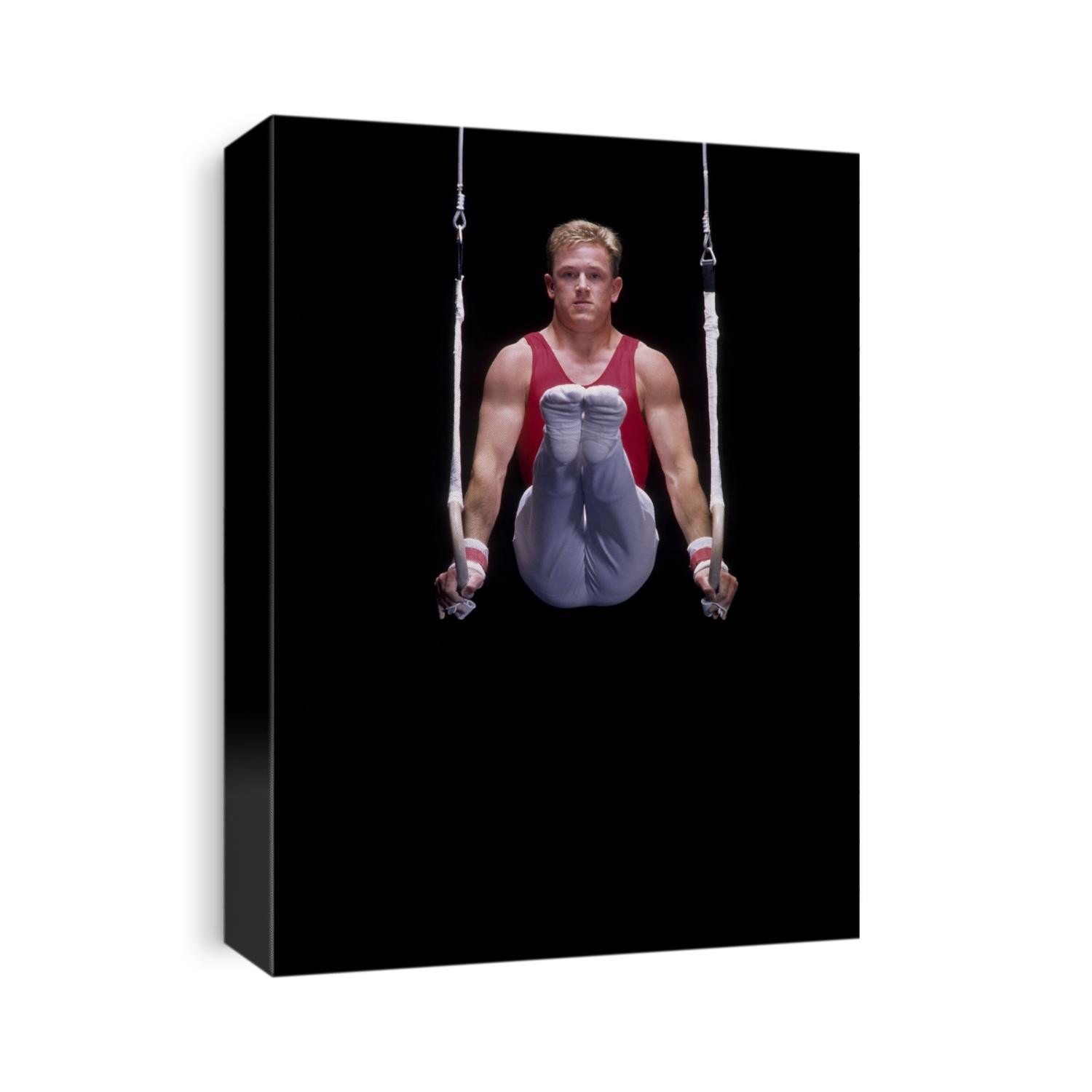 Male gymnast on the rings.