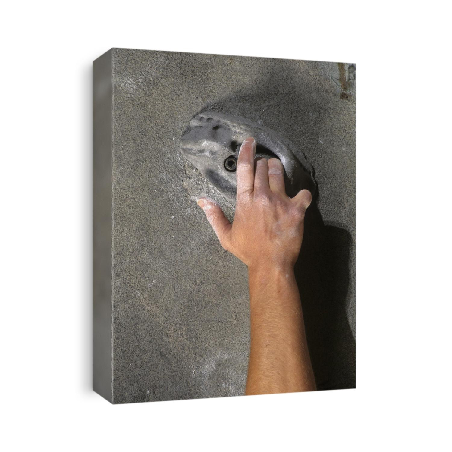 Detail of hand on wall climbing grip.