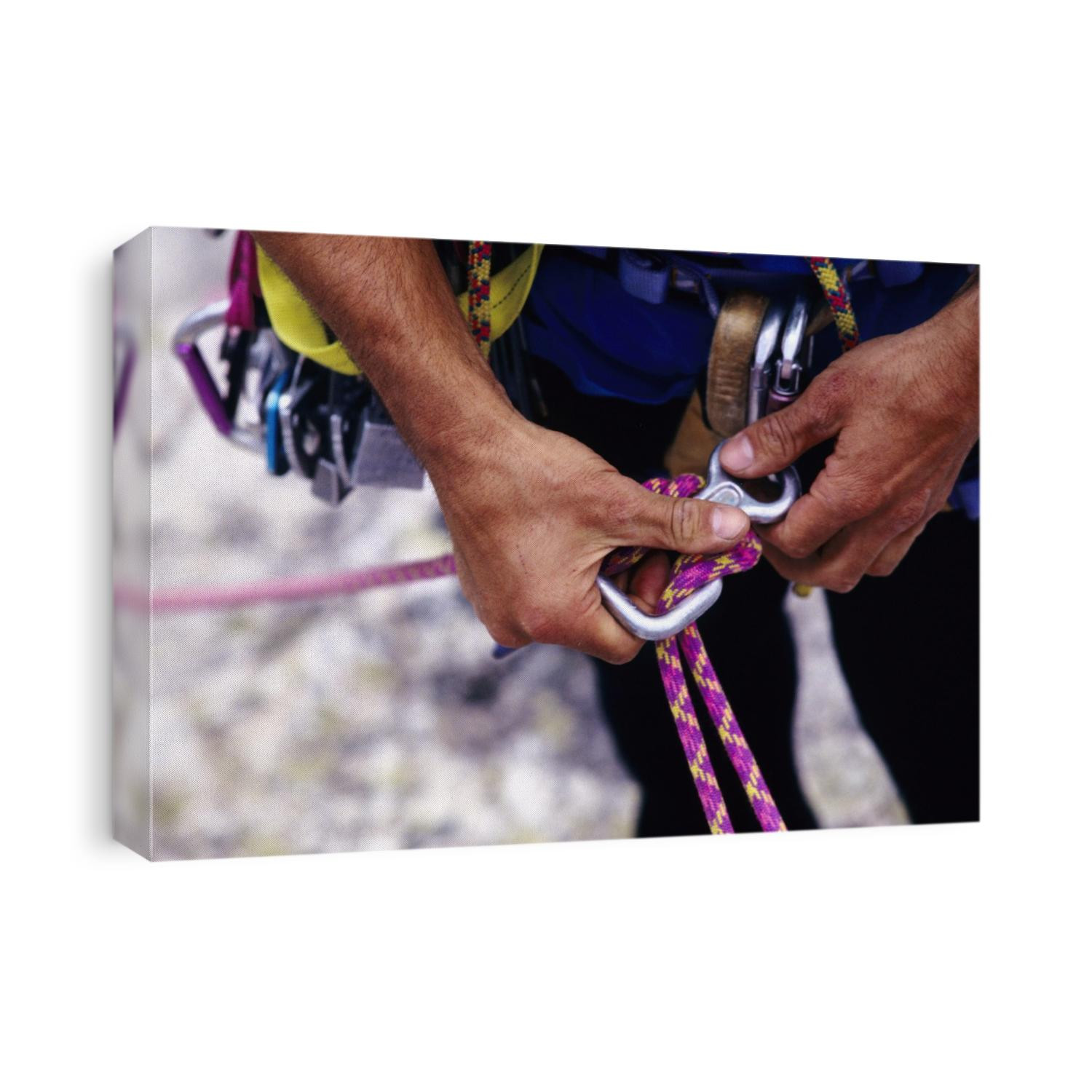 Climber adjusting carribiner and rope.