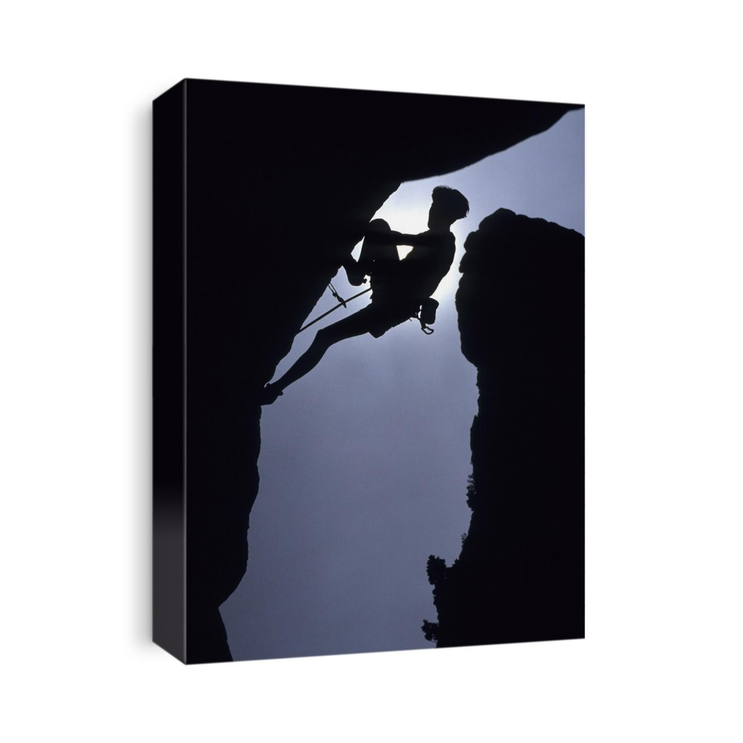 Silhouette of male rock climber.
