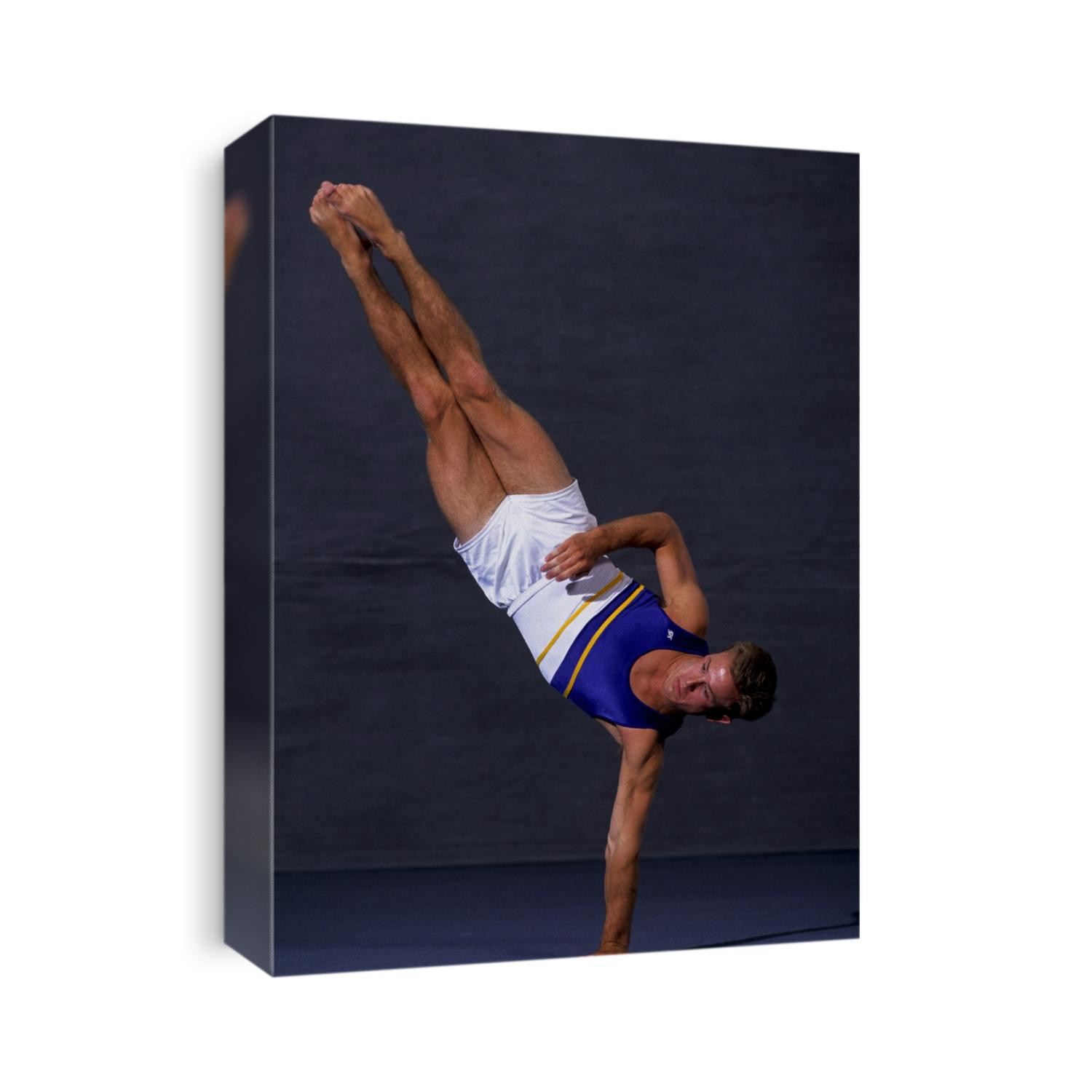 Male gymnast performing on the floor exercise.