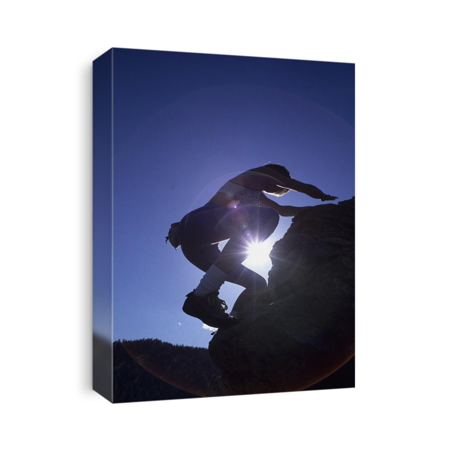 Woman rock climbing without equipment.