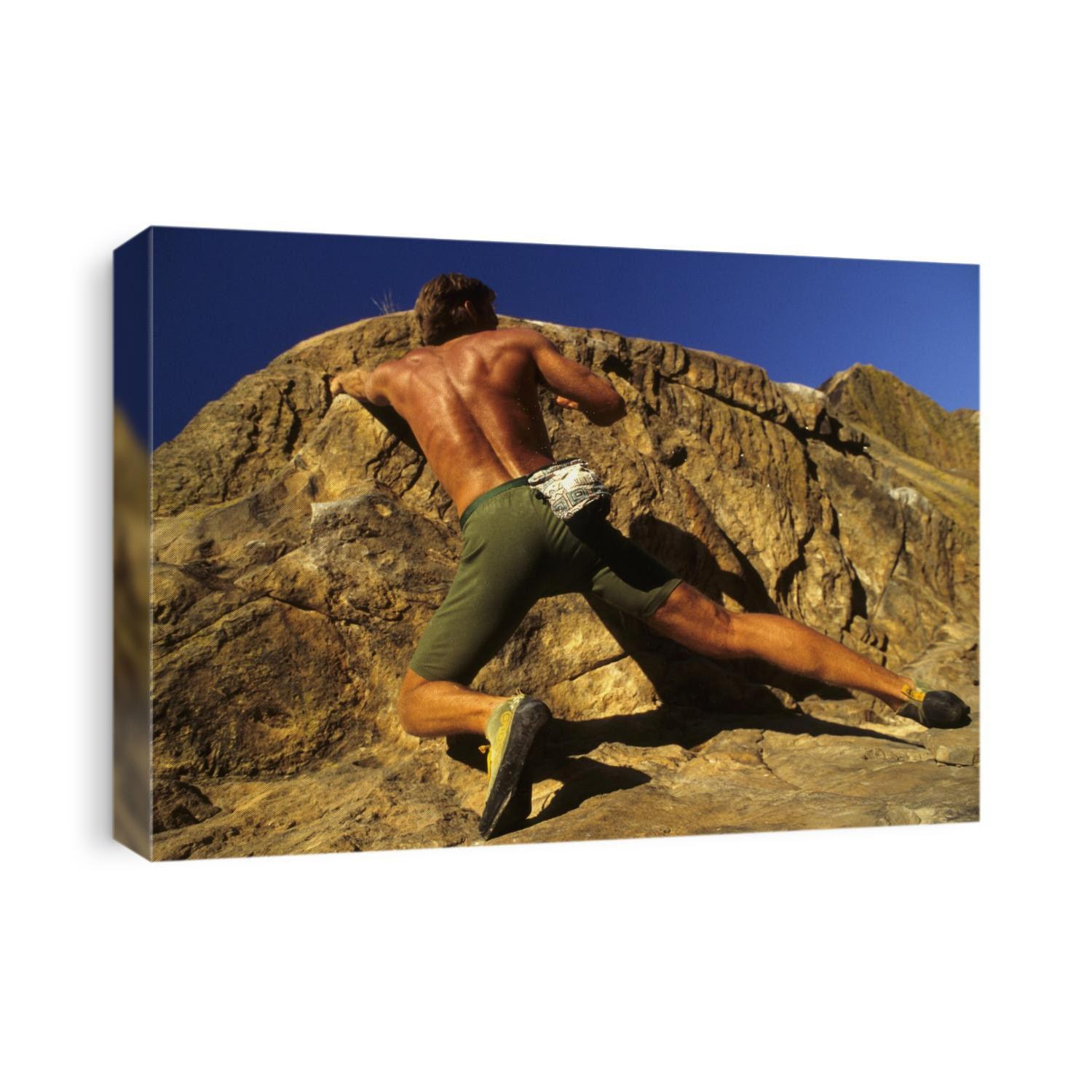 Man rock climbing without equipment.
