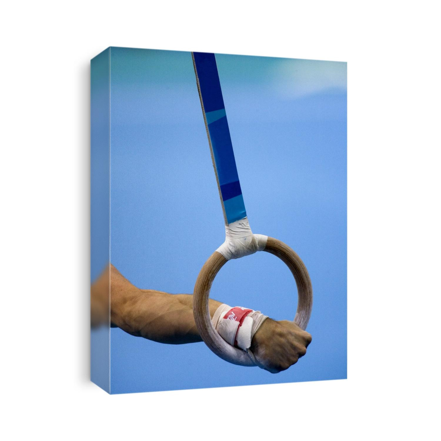Detail of male gymnast competing on the rings.