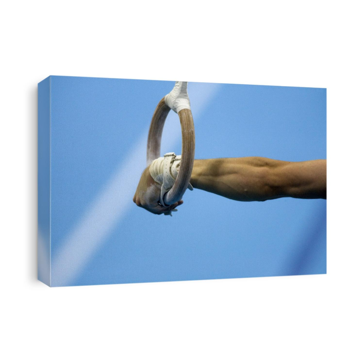 Detail of male gymnast competing on the rings