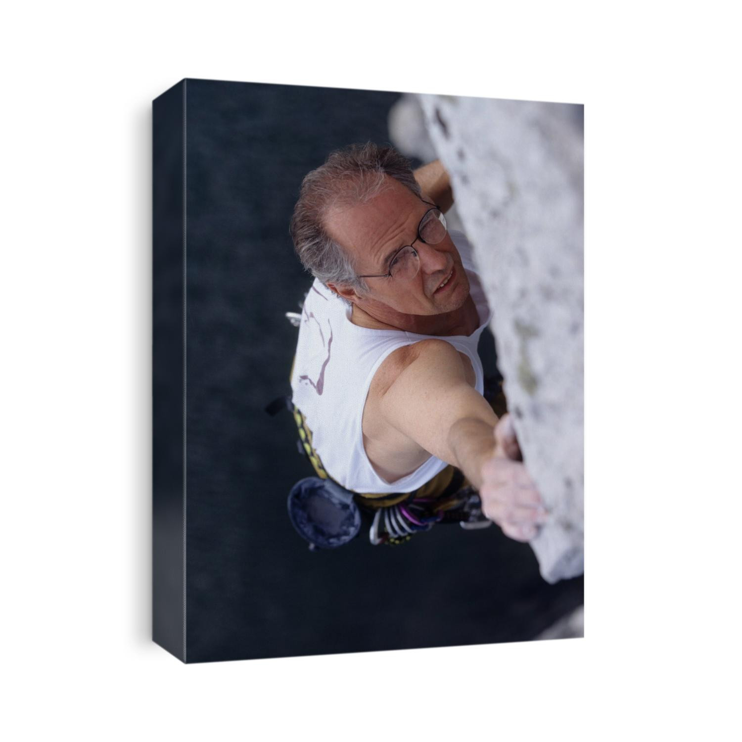 Mature man rock climbing