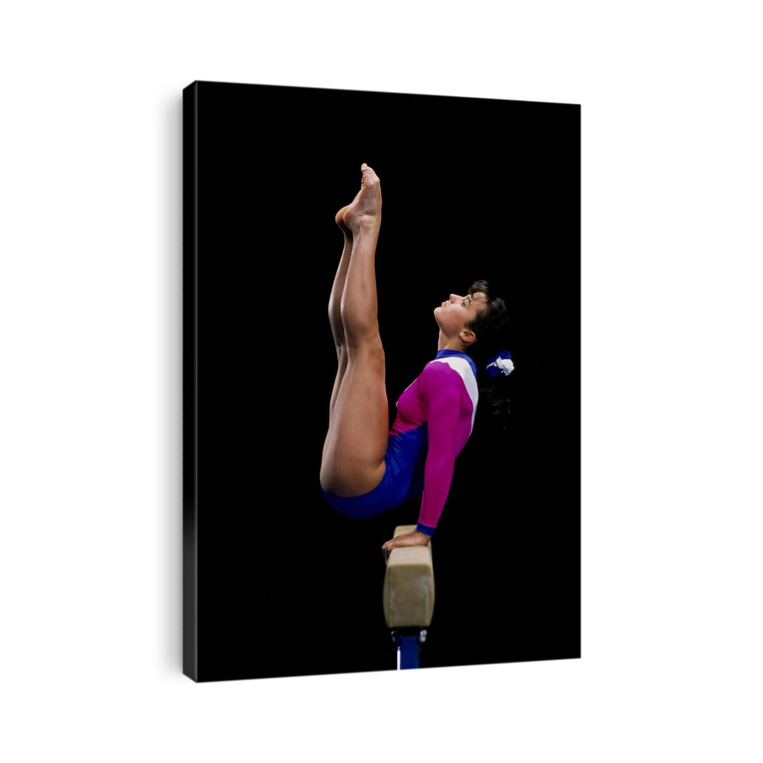 Female gymnast performing on the balance beam.